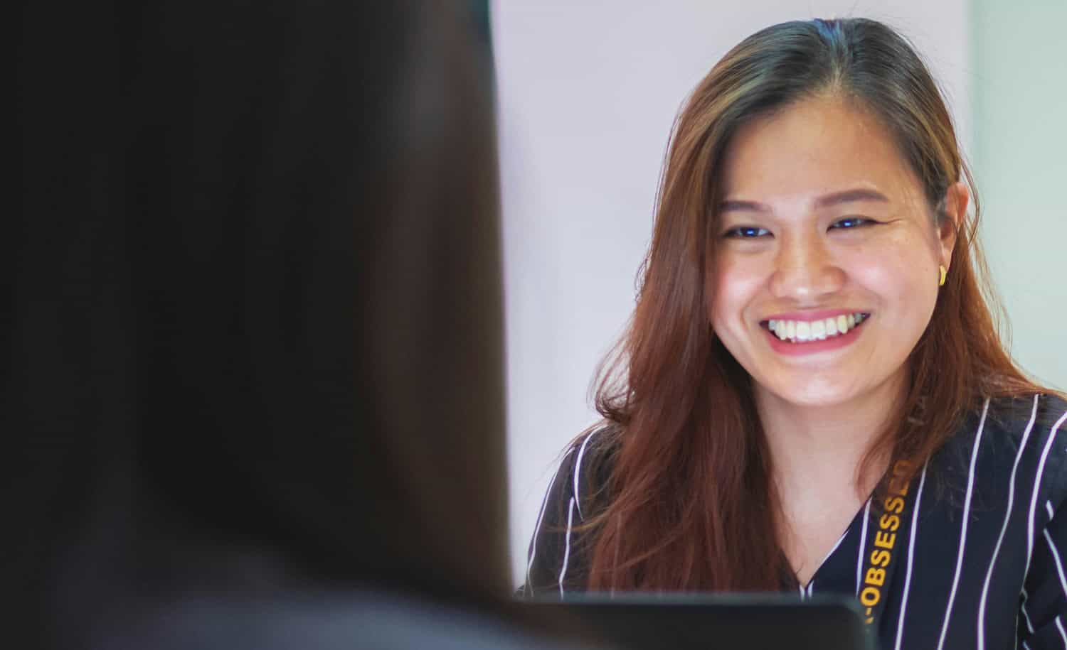 Woman at work, using a computer, looking at the screen